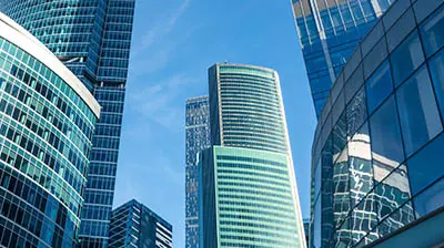 An Update On Our Business Continuity Plan Multiple tall skyscrapers  with the blue sky in the background